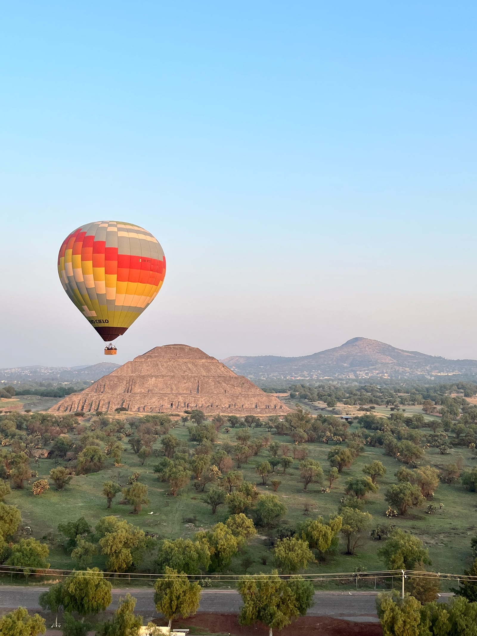 A hot-air balloon over the Pyramid of the Sun at Teotihuacán at dawn.