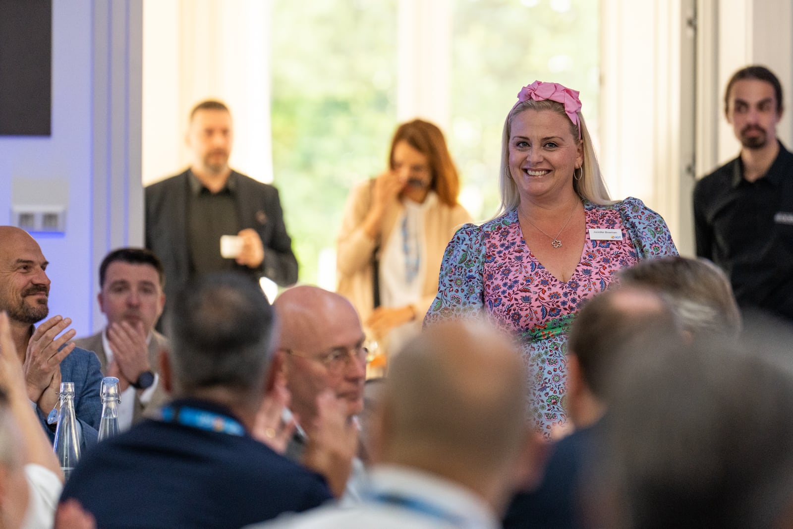 Jennifer in conversation with delegates at a conference reception.
